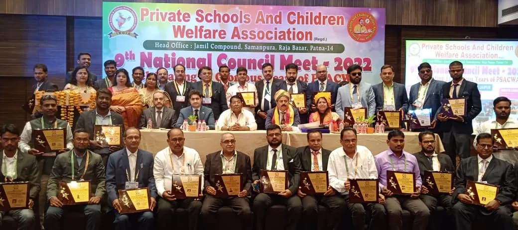 Award recipients holding plaques in a group photo at the 9th National Council Meet 2022