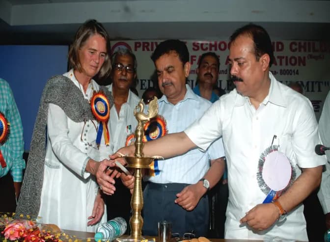 Guests light a ceremonial lamp at an association conference